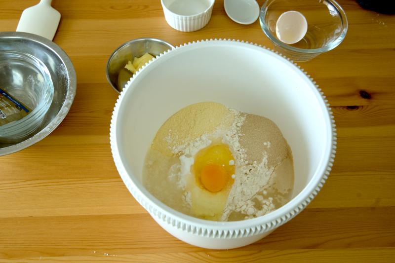 Combine bread flour, salt, milk powder, castor sugar, dry yeast, egg, and water in a large bowl.
