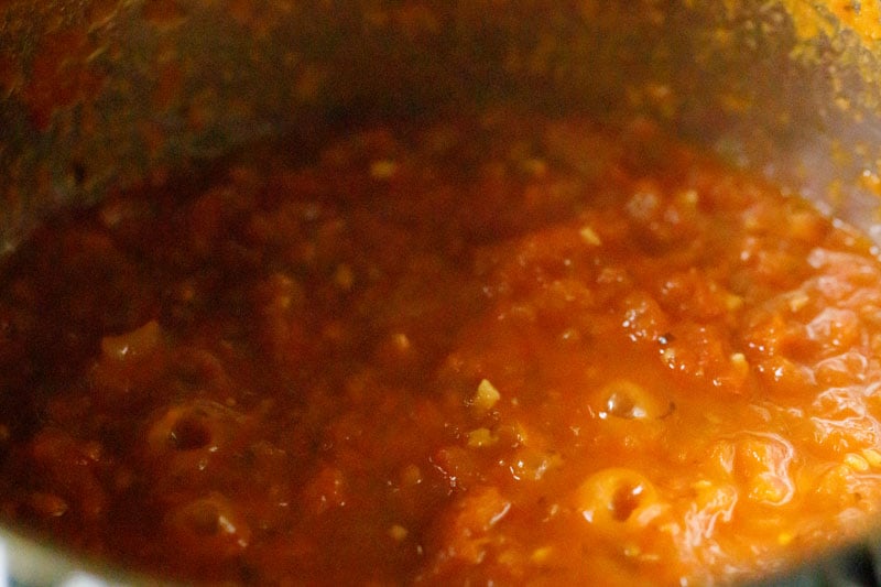 Marinara sauce bubbling in the skillet.