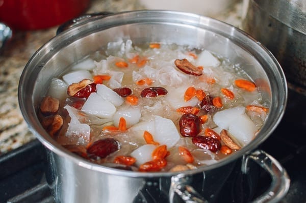 Adding dried dates, goji berries, and sugar