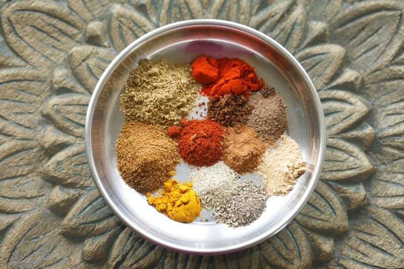 small mounds of ground spices to make shawarma in a plate.