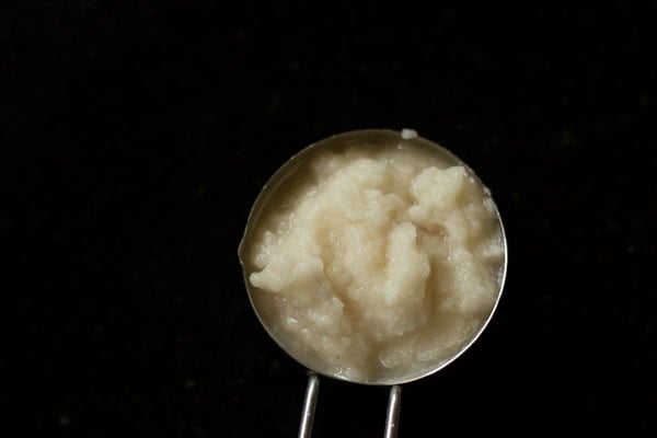 Prepared paste added in a bowl for making mushroom curry.