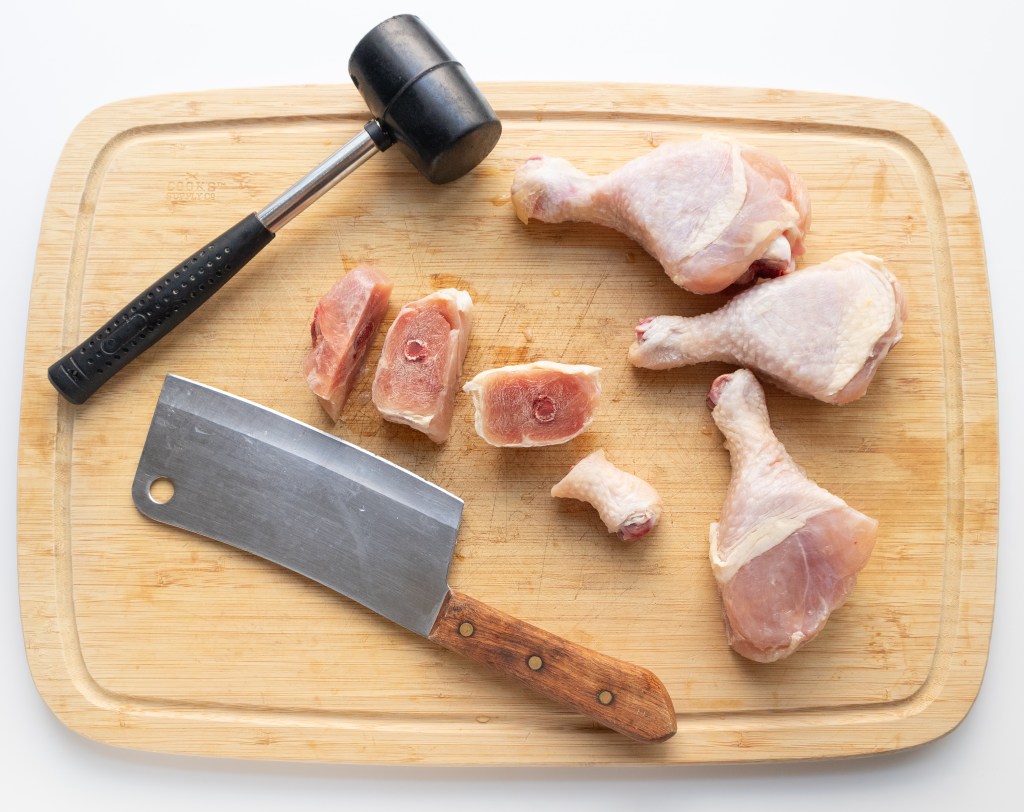 Cutting chicken for Vietnamese braised turmeric lemongrass chicken (Gà Kho Nghệ Sả)