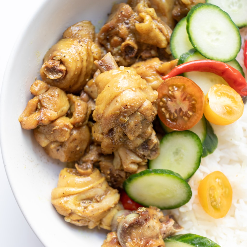 Vietnamese braised turmeric chicken (Gà Kho Nghệ) served with steamed rice and vegetables