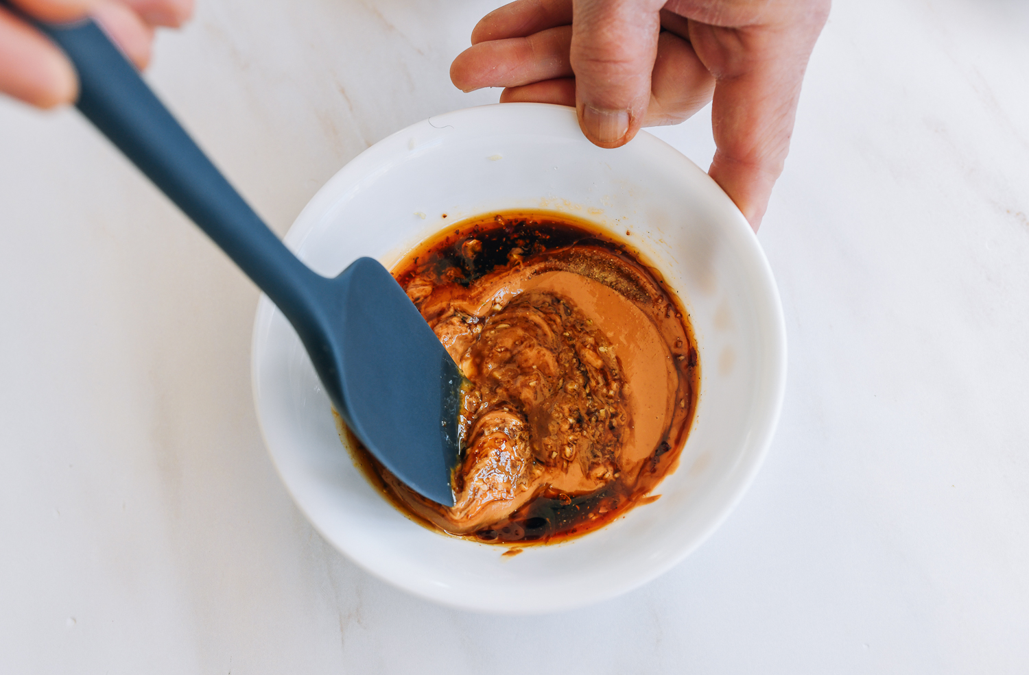 mixing peanut sauce in bowl