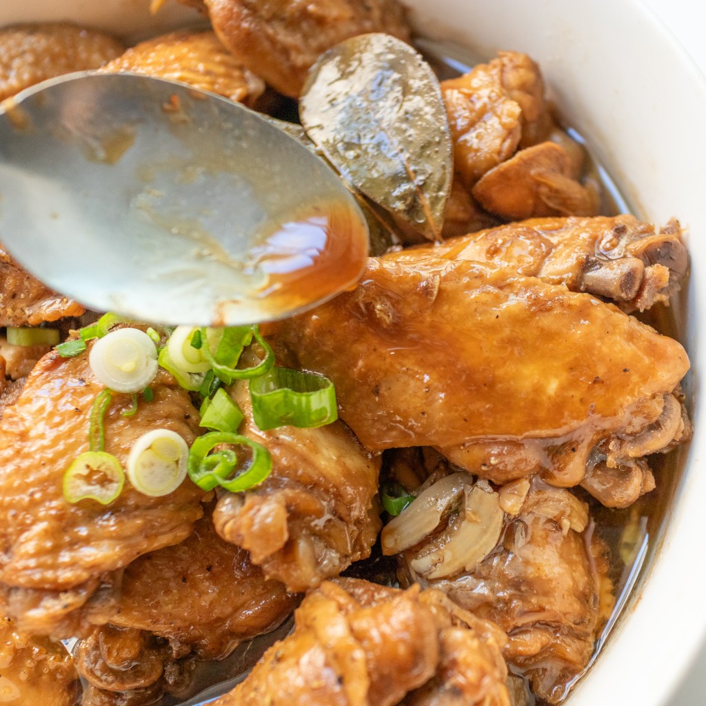 Easy Filipino Chicken Wing Adobo - Spooning sauce over