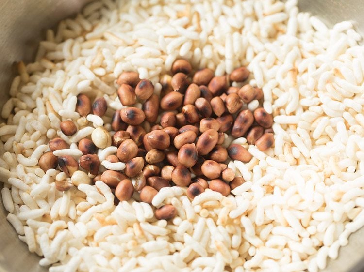 Roasted peanuts added to spiced puffed rice.