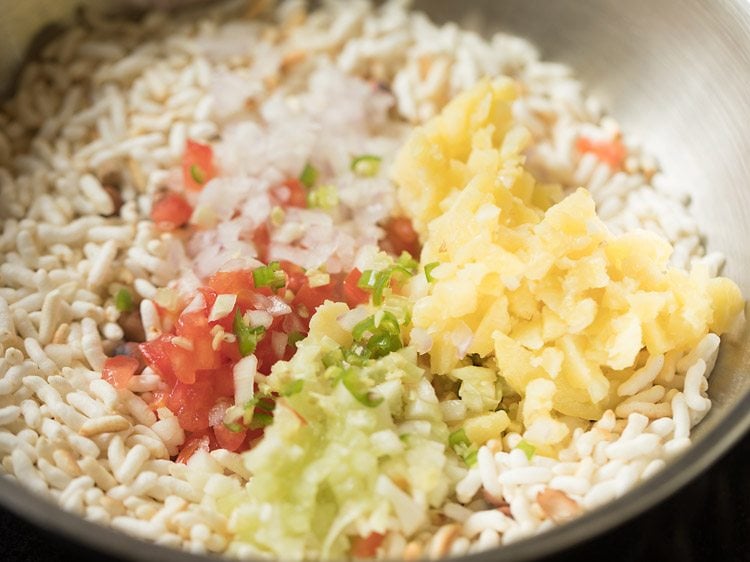 Finely chopped ingredients added to spiced puffed rice.