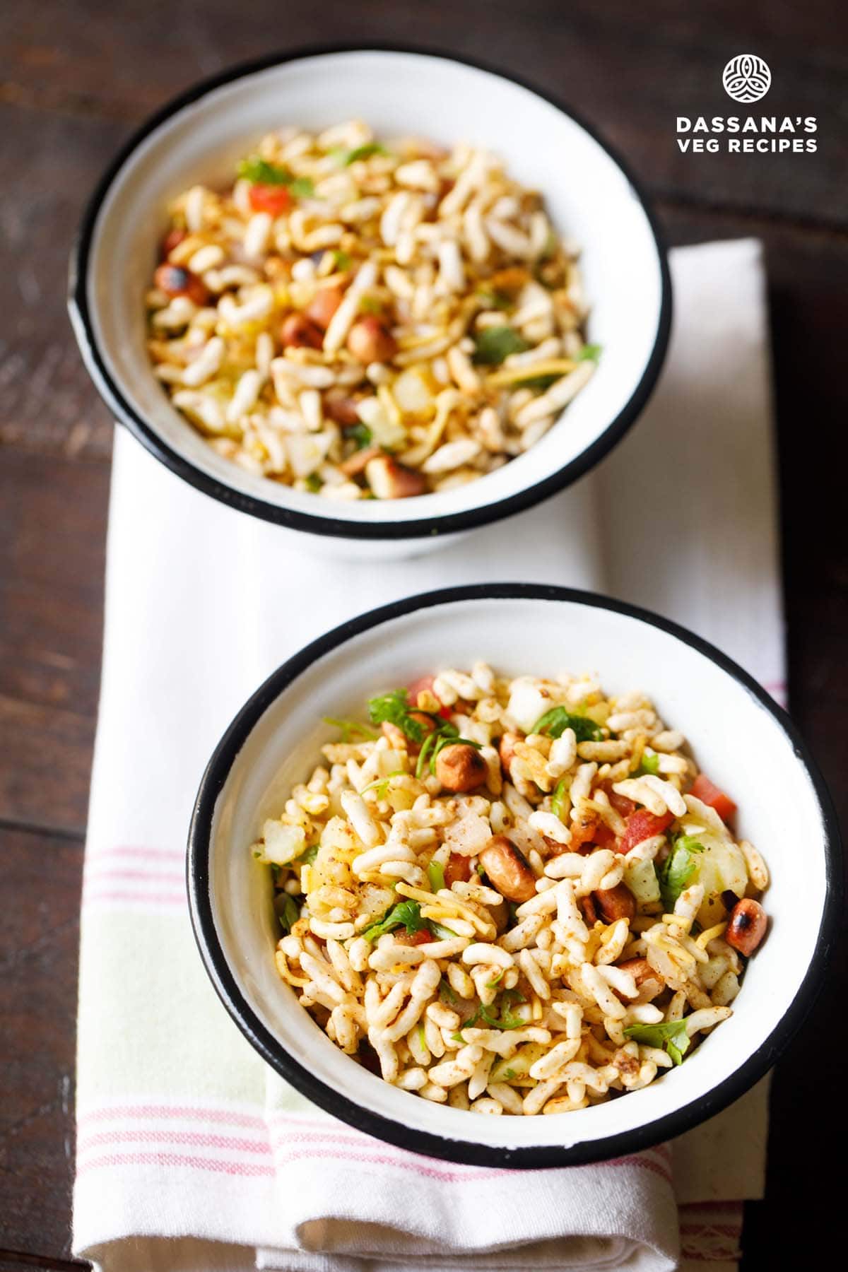 Jhal Muri in two black rimmed white bowls placed on a white napkin.